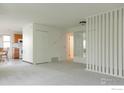 Open living space with view to kitchen with white appliances and lots of storage at 3345 Chisholm Trl # 206, Boulder, CO 80301