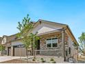 Charming two-story home featuring stone accents, a covered porch, and a two-car garage enhancing its curb appeal at 4327 Gypsum Ave, Mead, CO 80504