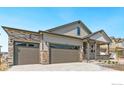 Inviting two-story home featuring stone accents and a three-car garage enhancing its curb appeal at 4327 Gypsum Ave, Mead, CO 80504