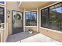 Charming front porch featuring a decorative wreath, potted plants, and sun-filled windows at 5904 Gunbarrel Ave # B, Boulder, CO 80301