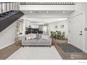 Inviting living room with sleek staircase, open layout, contemporary furnishings, and ample natural light at 5904 Gunbarrel Ave # B, Boulder, CO 80301