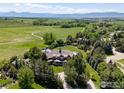 Expansive aerial view of estate with rolling hills and lush greenery at 6487 Cherry Ct, Niwot, CO 80503