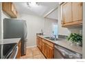 Well-lit kitchen with stainless steel appliances, granite countertops, and tile flooring at 715 Arapahoe Ave # 2, Boulder, CO 80302