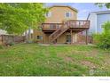 Spacious backyard featuring a large wooden deck, and a grassy area for outdoor activities at 903 Grays Peak Dr, Superior, CO 80027