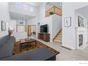 Bright living room featuring vaulted ceilings, fireplace, and a staircase at 903 Grays Peak Dr, Superior, CO 80027