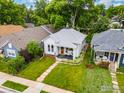 Aerial view of a lovely home with lush green lawn and mature trees in a quiet neighborhood at 1013 La Farge Ave, Louisville, CO 80027