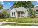 Beautifully maintained home with a quaint front porch and well-kept lawn at 1013 La Farge Ave, Louisville, CO 80027