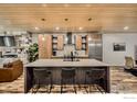 Bright kitchen features wooden cabinets, stainless steel appliances, and an island with bar stool seating at 1109 Neon Forest Cir # 2, Longmont, CO 80504