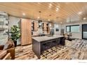 Well-appointed kitchen featuring modern appliances, a central island with seating and stylish wood accents at 1109 Neon Forest Cir # 2, Longmont, CO 80504