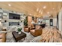 Spacious living room with fireplace, wood ceiling, hardwood floors and comfortable seating at 1109 Neon Forest Cir # 2, Longmont, CO 80504