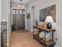 Inviting entryway featuring a rustic wood door, stylish lighting, and a charming console table at 1255 Eliza Ave, Berthoud, CO 80513