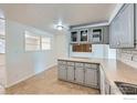 Charming kitchen featuring grey cabinets, tile floors, and modern lighting at 131 E 15Th Ave, Longmont, CO 80504
