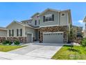 Two-story home featuring stone accents, a three-car garage, and a well-maintained lawn at 1389 Lyons Ln, Erie, CO 80516