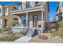 Charming two-story home with a covered front porch, second story balcony, and metal railing at 1419 W 67Th Ave, Denver, CO 80221