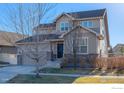 Traditional two-story home with a brick-accented front, showcasing a cozy and inviting facade at 1435 Rustic Dr, Longmont, CO 80504