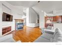 Open living room with hardwood floors, a fireplace, and ample seating, perfect for entertaining at 1513 Cannon Mountain Dr, Longmont, CO 80503