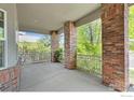 Covered patio area featuring brick columns and a railing, offering a relaxing outdoor space at 1513 Cannon Mountain Dr, Longmont, CO 80503