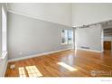 Bright and airy living room featuring hardwood floors and modern lighting at 166 Monares Ln, Erie, CO 80516