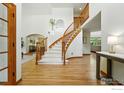 Elegant entryway featuring a curved staircase with wooden banister and hardwood floors at 1900 Eldorado Cir, Superior, CO 80027