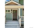 Close-up of the front door with glass panes and a light-blue painted facade at 1944 Arapahoe Ave # A, Boulder, CO 80302