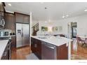Modern kitchen features stainless steel appliances, hardwood floors, and an island with a sink at 1944 Arapahoe Ave # A, Boulder, CO 80302