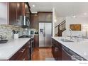Contemporary kitchen boasts stainless steel appliances, a breakfast bar and wooden floors at 1944 Arapahoe Ave # A, Boulder, CO 80302