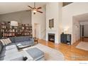 Bright living room featuring a cozy fireplace, high ceilings and custom bookshelf at 2975 Thunder Lake Cir, Lafayette, CO 80026