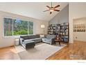 Inviting living room features a comfortable sectional sofa, hardwood floors and a custom bookshelf at 2975 Thunder Lake Cir, Lafayette, CO 80026