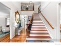 Elegant foyer featuring hardwood floors, staircase with iron railings, and wainscoting at 3000 E Cedar Ave # 2, Denver, CO 80209