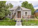 Inviting home exterior featuring a quaint front porch, landscaped lawn, and a welcoming facade at 340 Vivian St, Longmont, CO 80501