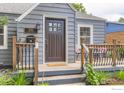Close-up of the front porch featuring cozy seating, a well-kept lawn, and an inviting entrance at 340 Vivian St, Longmont, CO 80501