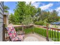 Cozy front porch with a decorative chair and view of the lovely, green landscaped front yard at 340 Vivian St, Longmont, CO 80501
