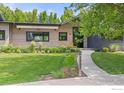 Well maintained lawn with a walkway leading to the modern home's entrance and a comfortable seating area at 3863 57Th St, Boulder, CO 80301