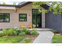 Inviting front porch with wood plank siding and a seating area for relaxing outdoors at 3863 57Th St, Boulder, CO 80301
