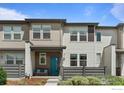 Beautiful townhome with a charming exterior, well-kept lawn and modern design at 4774 Kittredge St, Denver, CO 80239