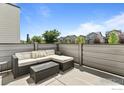 Relaxing outdoor patio featuring comfortable seating and privacy fencing at 4774 Kittredge St, Denver, CO 80239