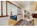 Inviting foyer with brick flooring and an open view to the living room and kitchen at 610 S Broadway Ave, Fort Lupton, CO 80621