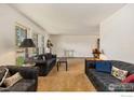 Bright living room with large windows, neutral carpet, and comfortable seating at 610 S Broadway Ave, Fort Lupton, CO 80621