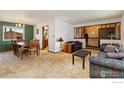 Open concept living room with dining area, featuring carpet and comfortable seating at 610 S Broadway Ave, Fort Lupton, CO 80621