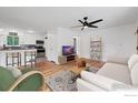 Bright living room with hardwood floors, white walls, and modern decor with an open layout at 6755 W 33Rd Ave, Wheat Ridge, CO 80033
