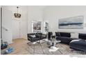 Bright living room featuring high ceilings, and large windows at 6924 Quigley Cir, Firestone, CO 80504