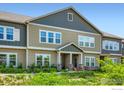 Inviting townhouse with manicured lawn, showcasing its attractive curb appeal and modern design at 876 Winding Brook Dr, Berthoud, CO 80513