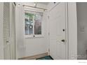 Bright foyer featuring a white door, window, closet, and neutral decor at 1113 Elysian Field Dr. # A, Lafayette, CO 80026