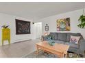 Cozy living room with decor, rug, comfortable seating, and neutral walls at 1113 Elysian Field Dr. # A, Lafayette, CO 80026