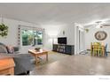 Spacious living room featuring a large window and dining area with backyard access at 1113 Elysian Field Dr. # A, Lafayette, CO 80026