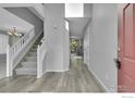 Bright foyer featuring wood-look flooring, staircase, and direct access to living spaces at 1226 Fremont Ct, Longmont, CO 80504