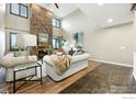 This bright and airy living room has tall ceilings and a floor-to-ceiling stone fireplace at 15810 E Tall Timber Ln, Parker, CO 80134