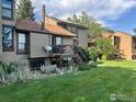 View of the townhouse showcasing the deck, landscaping, and exterior paint at 1624 Bradley Ct, Boulder, CO 80305