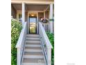 Inviting front porch with a stairway, adorned with decorative flowerpots, leading to the front door at 1668 Saratoga Dr, Lafayette, CO 80026