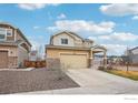 Charming home featuring an attached two-car garage, a well-maintained lawn, and front yard at 17995 E 107Th Pl, Commerce City, CO 80022